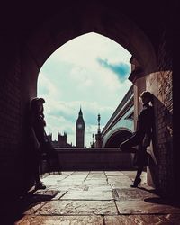 Man in city against cloudy sky