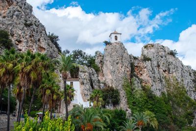 Low angle view of guadalest historic buildings on rocks of spanish mountains