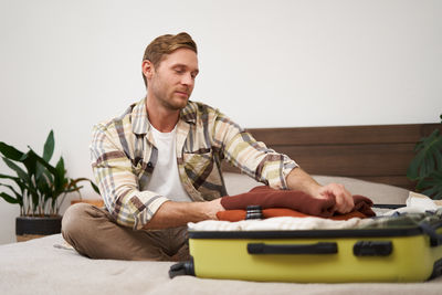 Portrait of senior man sitting on sofa at home