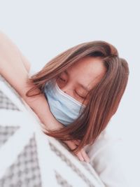 Close-up of beautiful woman lying on bed