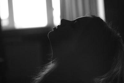Close-up of woman looking away at home