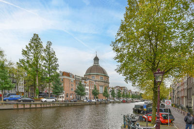 Boats in canal against sky