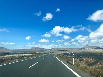 Empty road along countryside landscape