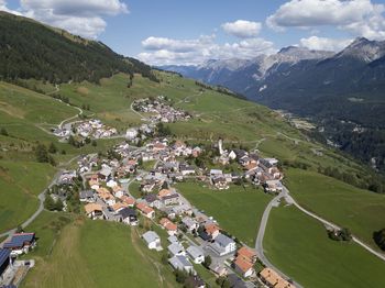 High angle view of houses and mountains against sky