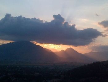 Scenic view of mountains against sky at sunset