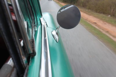 Close-up of car on road