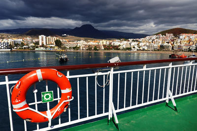 Boat on sea against cloudy sky