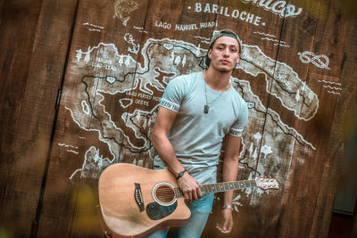 Portrait of a young man playing guitar