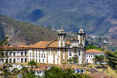Ancient colonial style churc in ouro preto city with hills in background