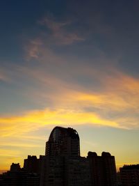 Silhouette city against sky during sunset