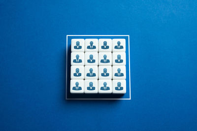 Directly above shot of dices on blue background