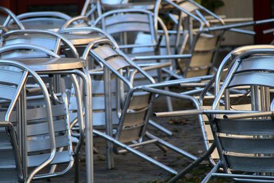 Metallic chairs and table at sidewalk cafe