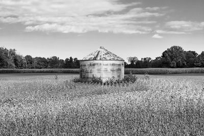 Built structure on field against sky