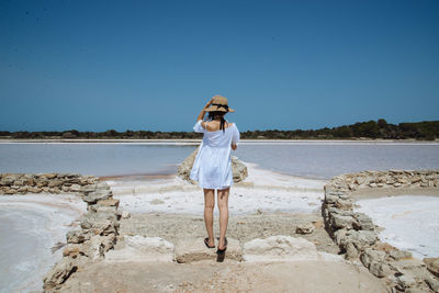 Woman standing in front of lake