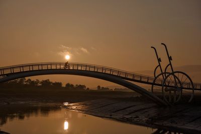 A bike on the bridge looking like a big bicycles