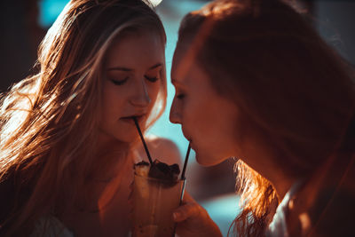 Close-up of female friends having drink