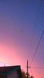 Low angle view of birds flying against clear sky