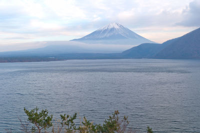 Scenic view of lake and mountains against sky