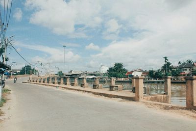 Road by city against sky