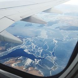 Aerial view of landscape seen through airplane window