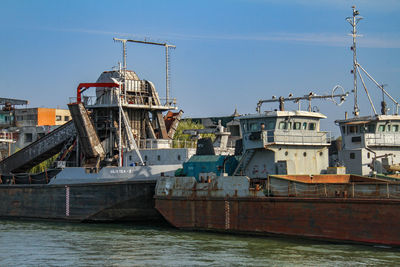 Ship moored at harbor against clear sky