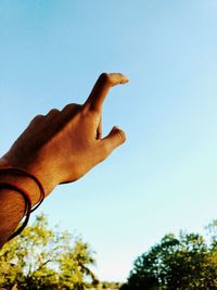 Low angle view of man against clear sky