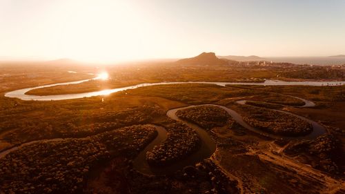 Aerial view of landscape against sky during sunset