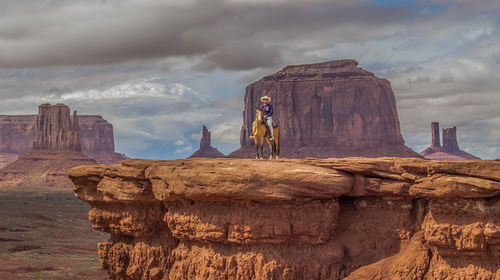 View of man riding horse against landscape