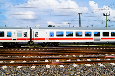 Passenger train on tracks against sky