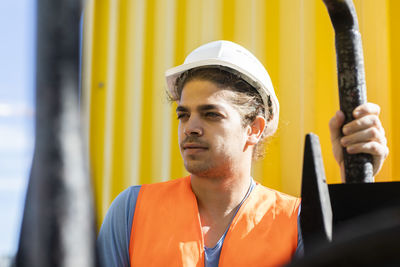 Young construction engineer with helmet working outside