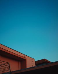 Low angle view of building against clear blue sky