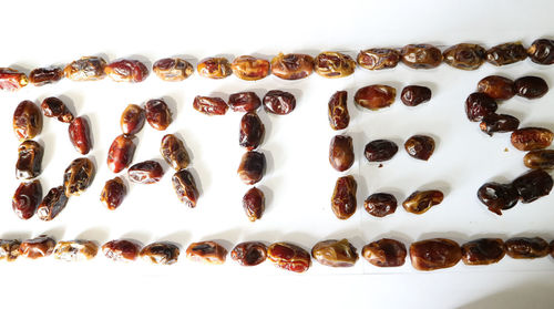 High angle view of coffee beans on white background