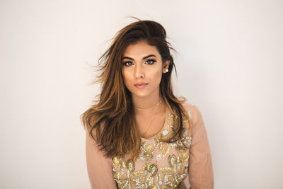 Portrait of a beautiful young woman over white background