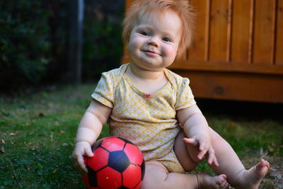 Portrait of cute girl playing with ball