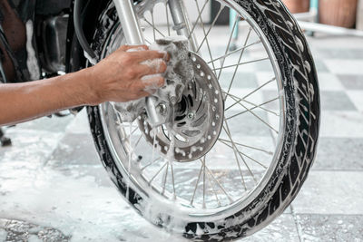 Close-up of hand holding bicycle wheel