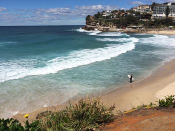 High angle view of surfer standing on beach