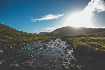 Scenic view of waterfall against sky