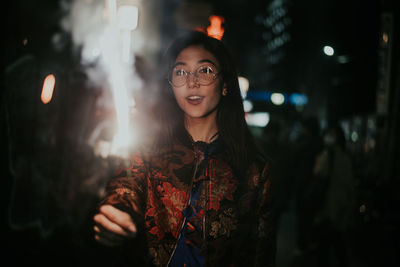 Portrait of smiling young woman standing outdoors