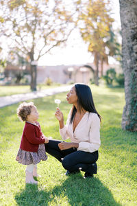Side view of mother and daughter in park