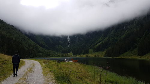 Scenic view of lake by trees against sky