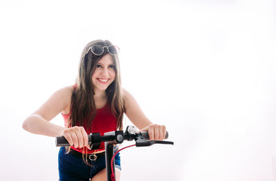 Portrait of smiling young woman riding bicycle