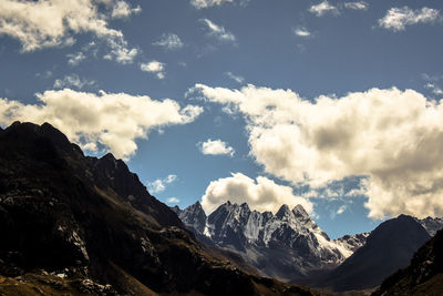 Scenic view of mountains against cloudy sky