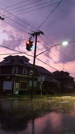 Power lines against cloudy sky