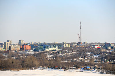 Buildings in city against clear sky