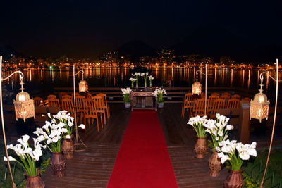 Arrangement of vase and chairs at wedding reception by river