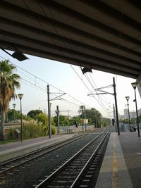 Empty railroad station platform against sky