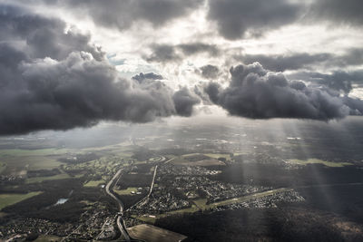 Aerial view of city against cloudy sky