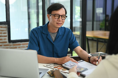 Young man using laptop at office