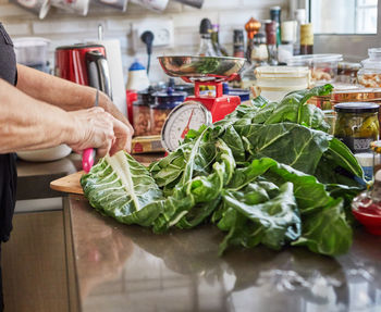 Midsection of man preparing food in kitchen