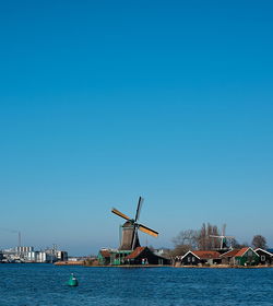 Windmill against clear blue sky